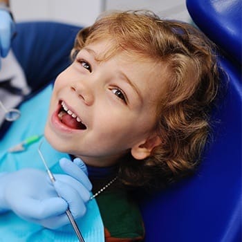Smiling toddler in dental chair