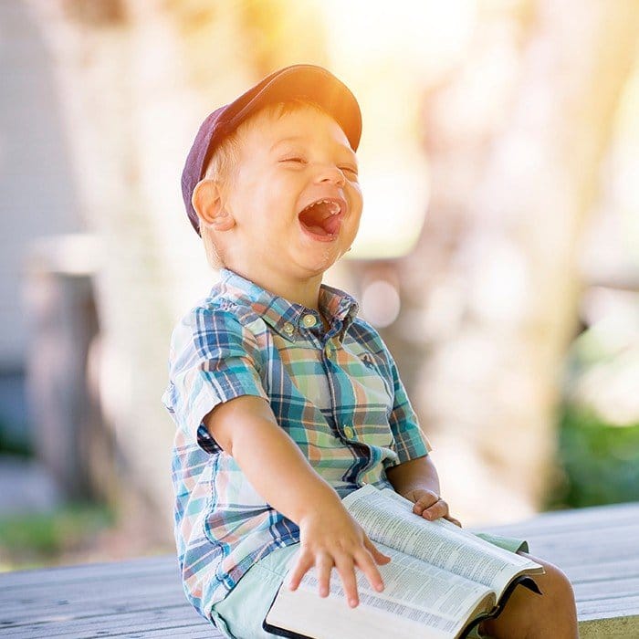 Laughing little boy on a dock