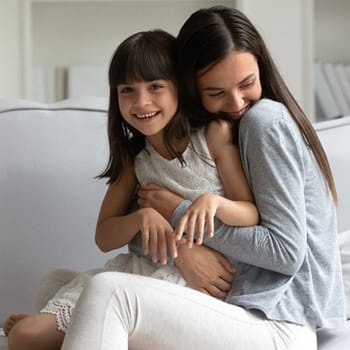 siblings hugging each other and smiling