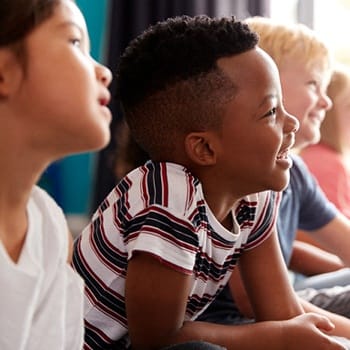 children sitting in class and listening