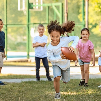 children playing football together