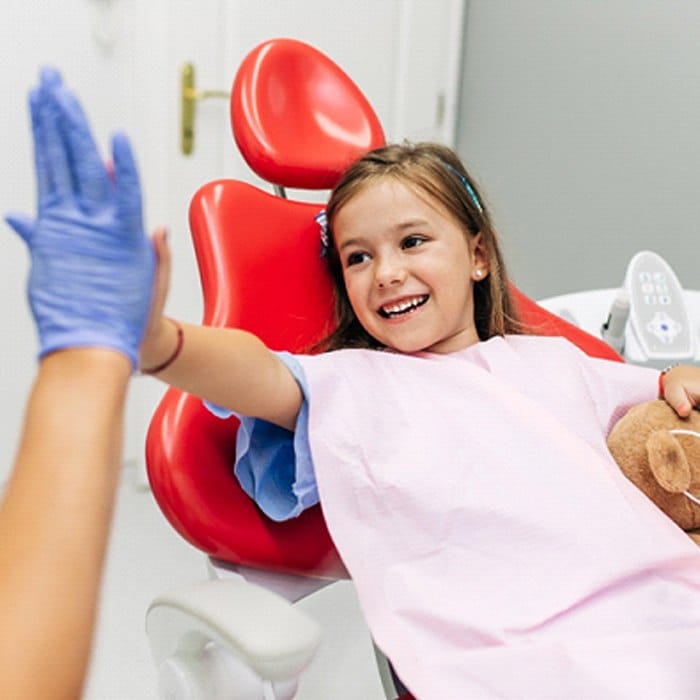 girl high-fiving her dentist