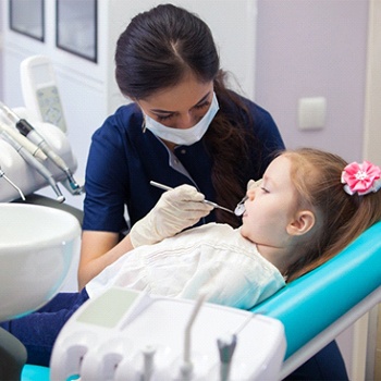 A little girl having her teeth examined by a dental hygienist 