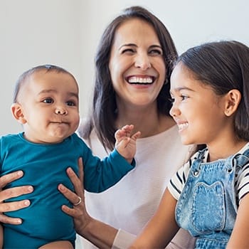 Smiling mother and two children