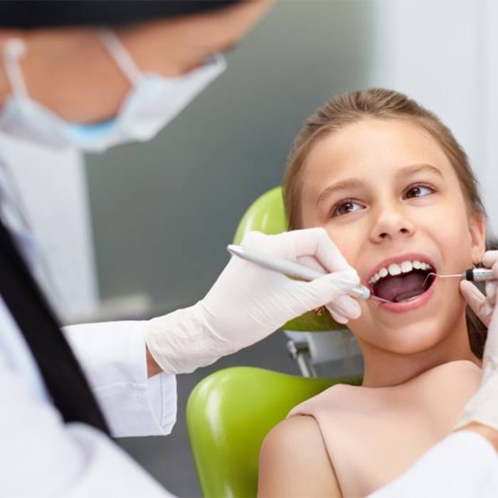 A young child having their dental exam.