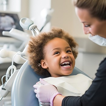 young girl smiling in dental chair 