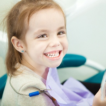 A little girl showing off her healthy teeth while at the dentist’s office in Duncanville