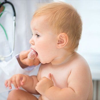 Dentist checking baby's new teeth