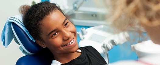 Smiling teen girl in dental chair