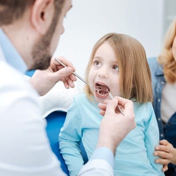 A child being checked for lip and tongue tie