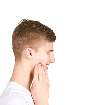 Profile of teen boy in white shirt with sore jaw