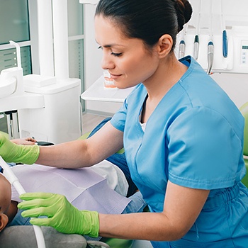 A dentist giving nitrous oxide sedation to a young boy