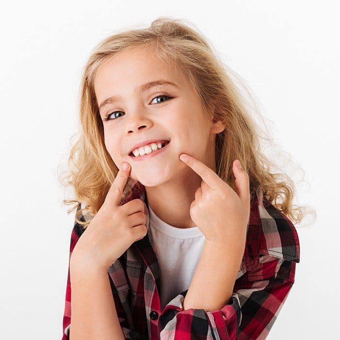 Little blonde girl smiling with a pedi-partial in Duncanville