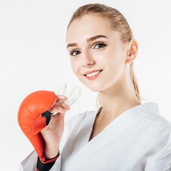 Teen girl placing a mouthguard