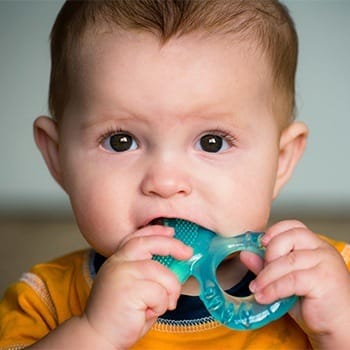 Baby chewing on teething ring