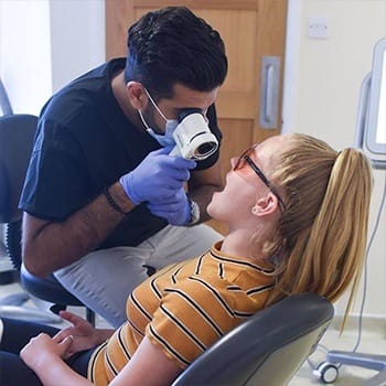 Teen girl receiving oral cancer screening