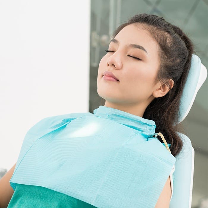 Relaxing young woman in dental chair
