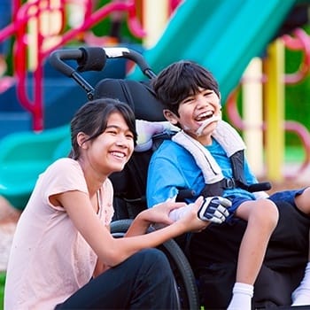 Two laughing teens outdoors