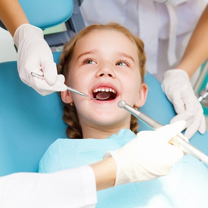 Little girl receiving dental exam