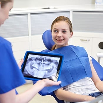 Child smiling in dental chair