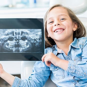 Little girl holding up her digital x-rays