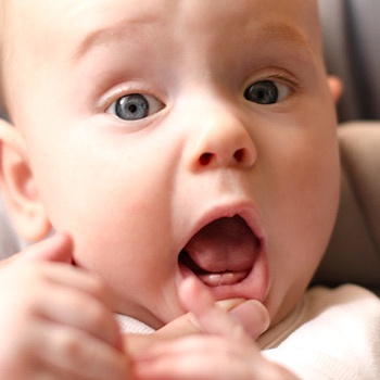 baby showing teeth after teething