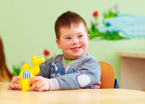 Young boy smiles during World Autism Awareness Day