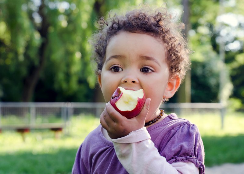 child eating an apple