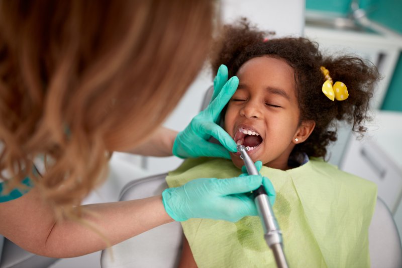 A child receiving oral conscious sedation from their dentist
