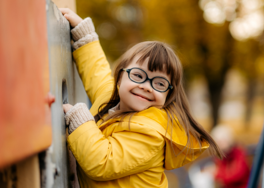 Child with down syndrome playing on playground