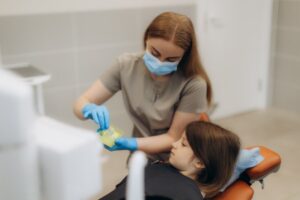 Child receiving fluoride treatment.